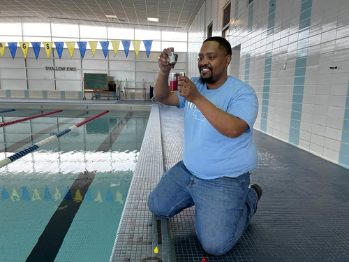 A technician checks pool water